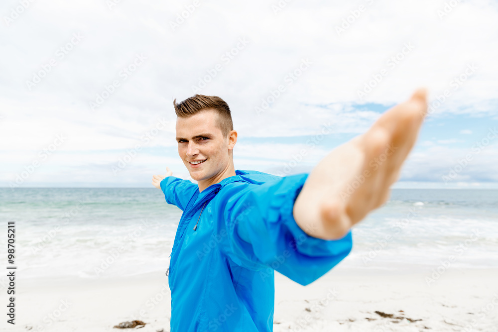 Young man in sport wear with outstretched arms Young man in sport wear with outstretched arms