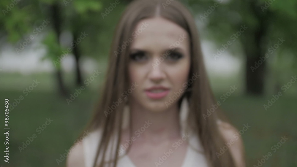 Camera moves to the person while beautiful woman with green eyes looks on it slow motion flat color Camera moves to the person while beautiful woman with green eyes looks on it slow motion flat color