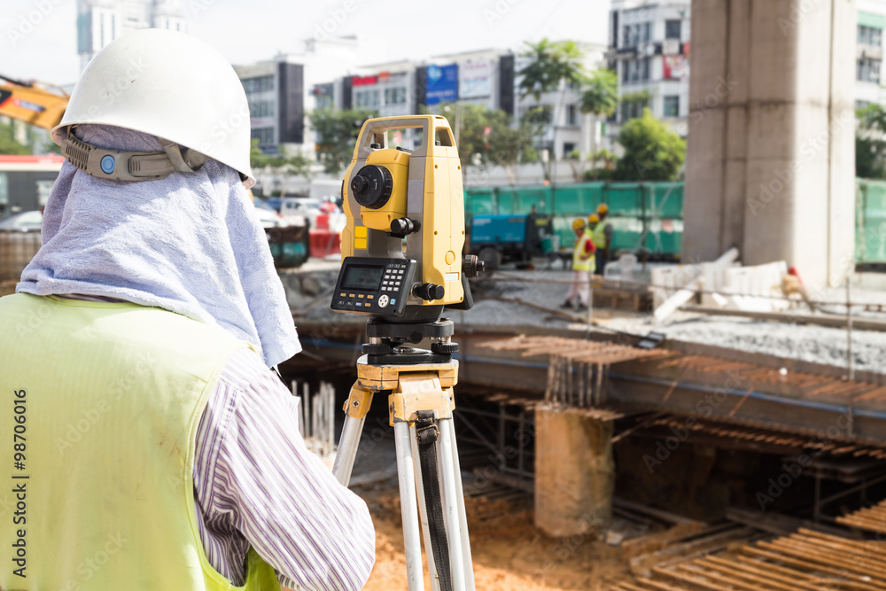 Fototapeta premium Engineer reviewing the dumpy automatic level instrument readings