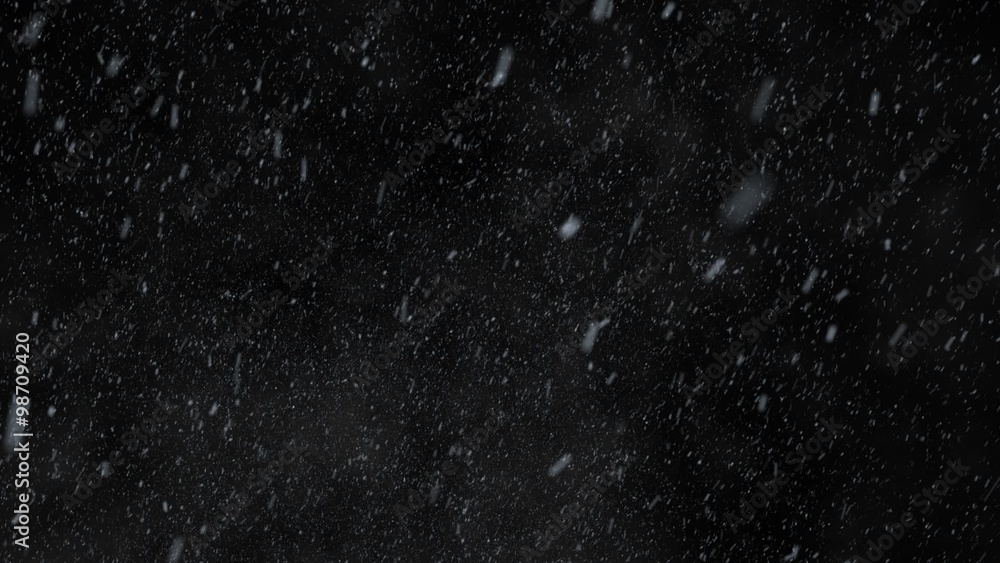 Winter snowfall. Low angle shot of a dense snow against a black background. Winter snowfall. Low angle shot of a dense snow against a black background.