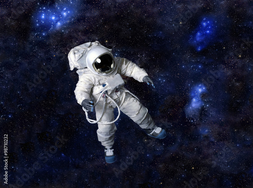 Astronaut floating in dark space.