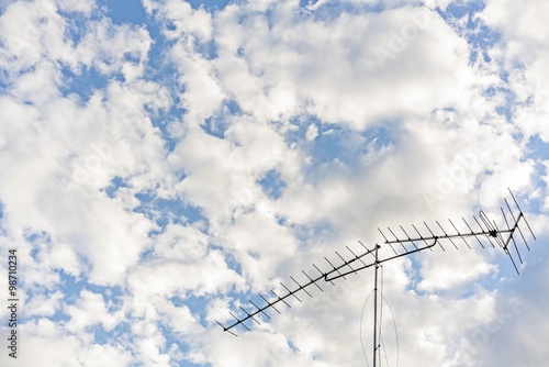 Broken televisions antennas with White cloudy sky background - copy space & your text design 