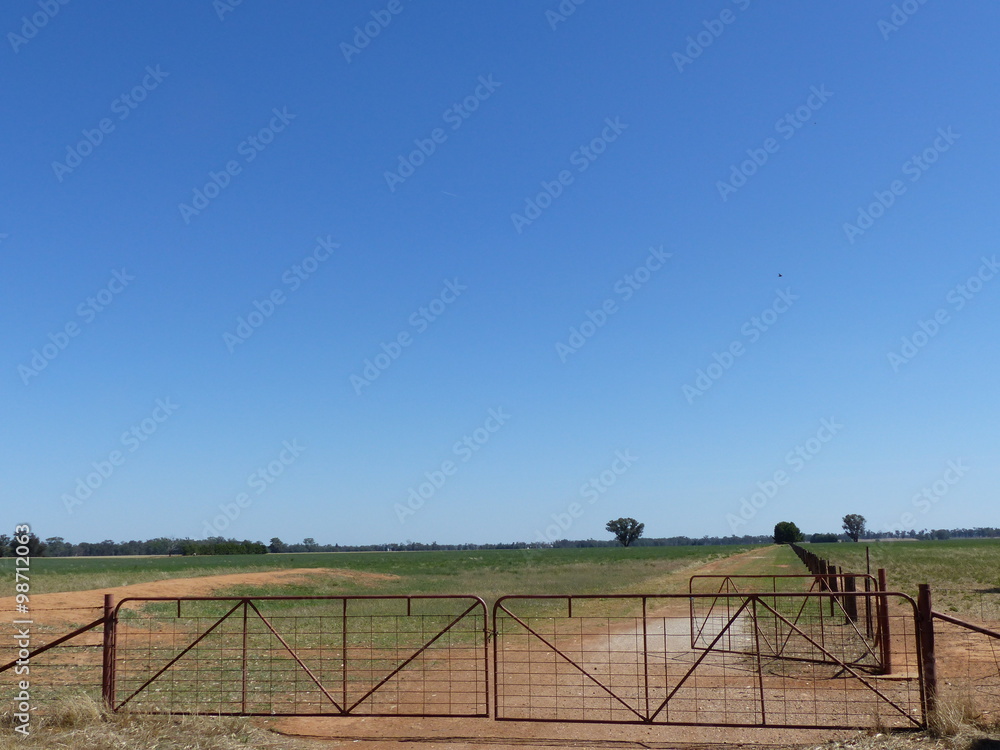 Rural closed gate and blue sky