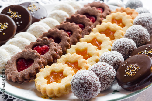Mixed christmas cookies on a white plate.