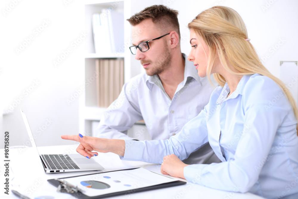 Two successful business partners working at meeting in office Two successful business partners working at meeting in office