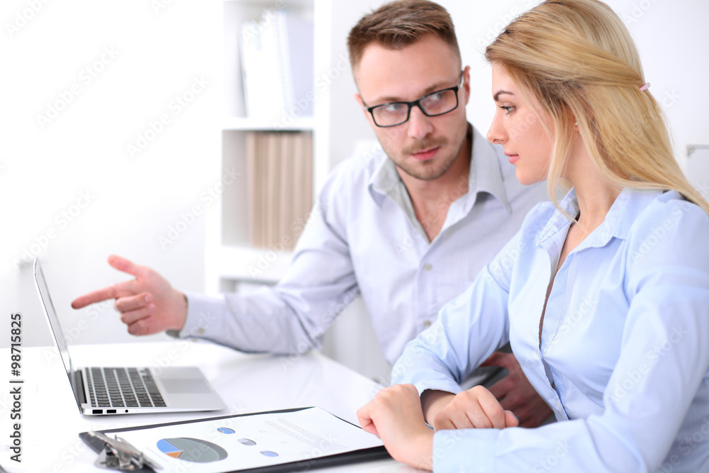Two successful business partners working at meeting in office Two successful business partners working at meeting in office
