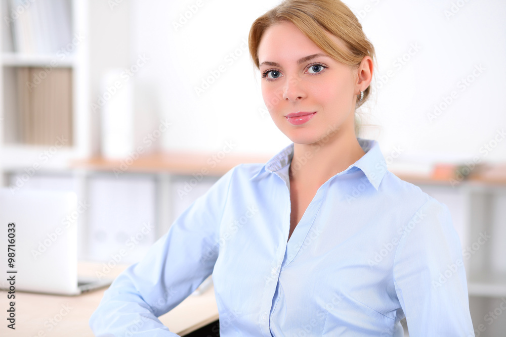 Young blonde business woman with laptop in the office. Business concept. Young blonde business woman with laptop in the office. Business concept.