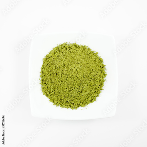 The Japanese matcha green tea powder on the mini white dish.