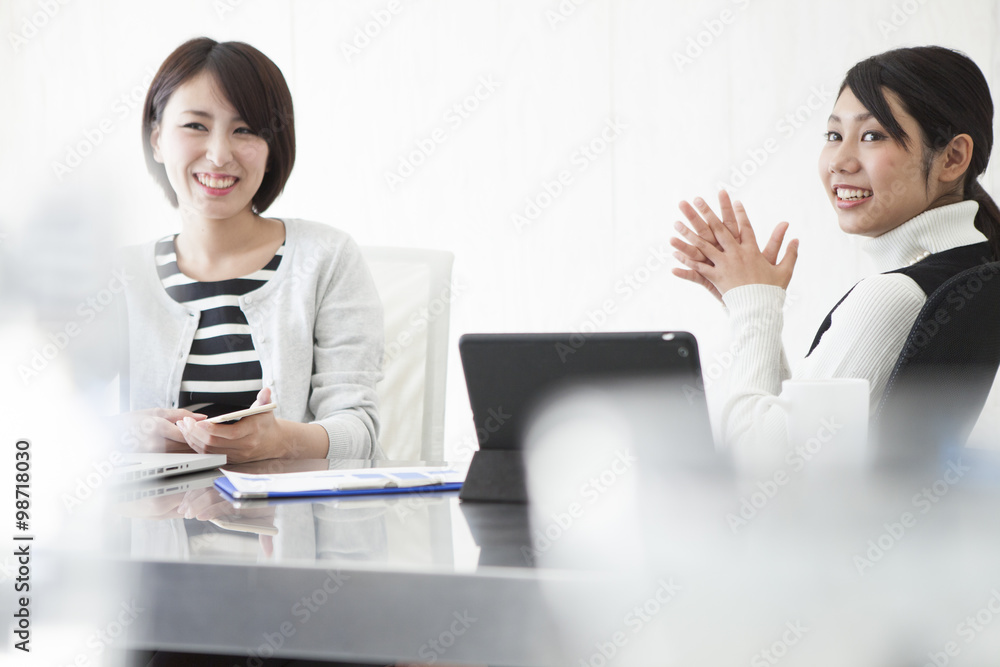 Women are talking to during a break in the office