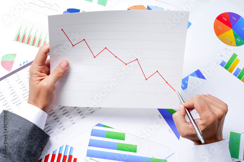 Canvas Print businessman observing a chart with a downward trend