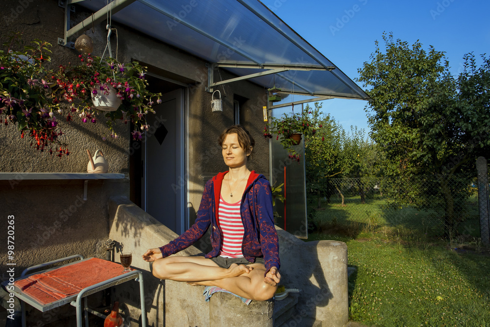 Girl meditating in the garden Girl meditating in the garden