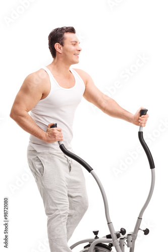 Young man exercising on a cross trainer