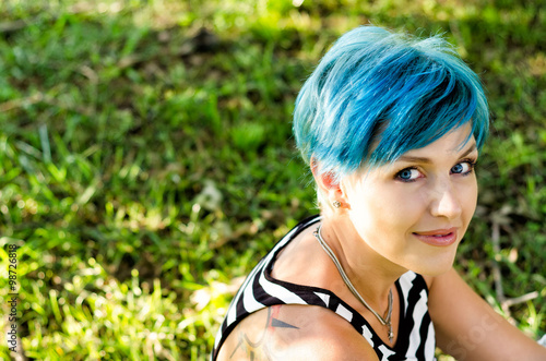 Beautiful girl with blue hairs looking in camera.