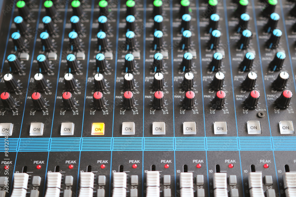 Close up of the rows of knobs and sliders on an analogue mixing Close up of the rows of knobs and sliders on an analogue mixing