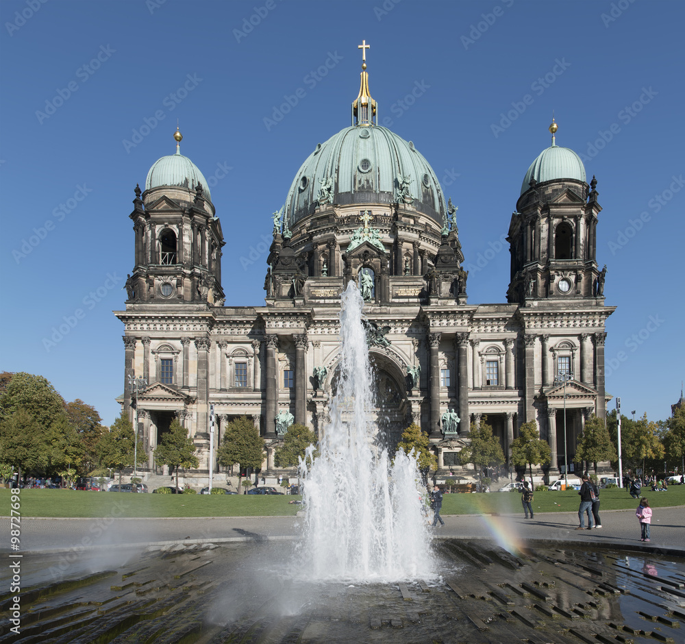 Berlin Cathedral. Fountain in front of the facade with rainbow. Berlin, Germany