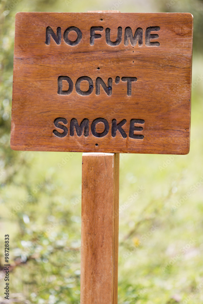 No smoking sign wooden rustic sign with blurred background