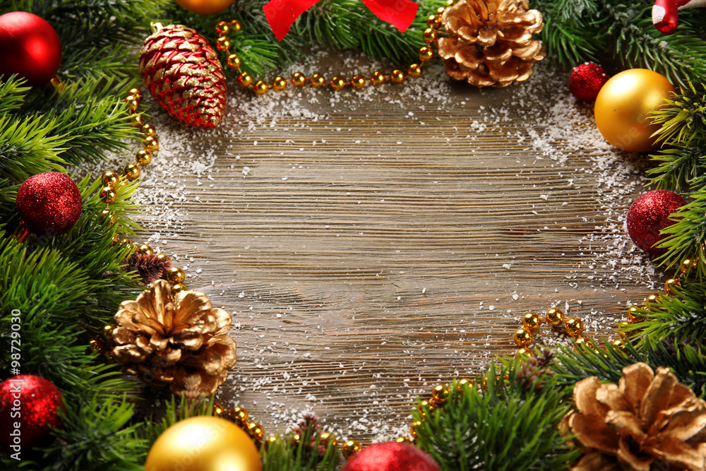 Christmas fir tree branches with toys on wooden table Christmas fir tree branches with toys on wooden table