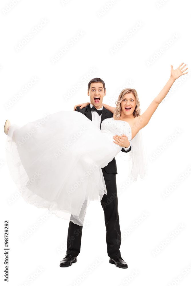 Young groom lifting his bride in his hands