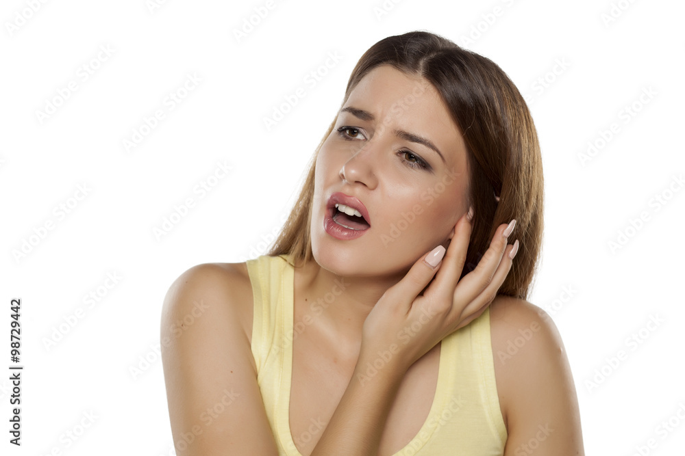beautiful young woman has pain in the ear