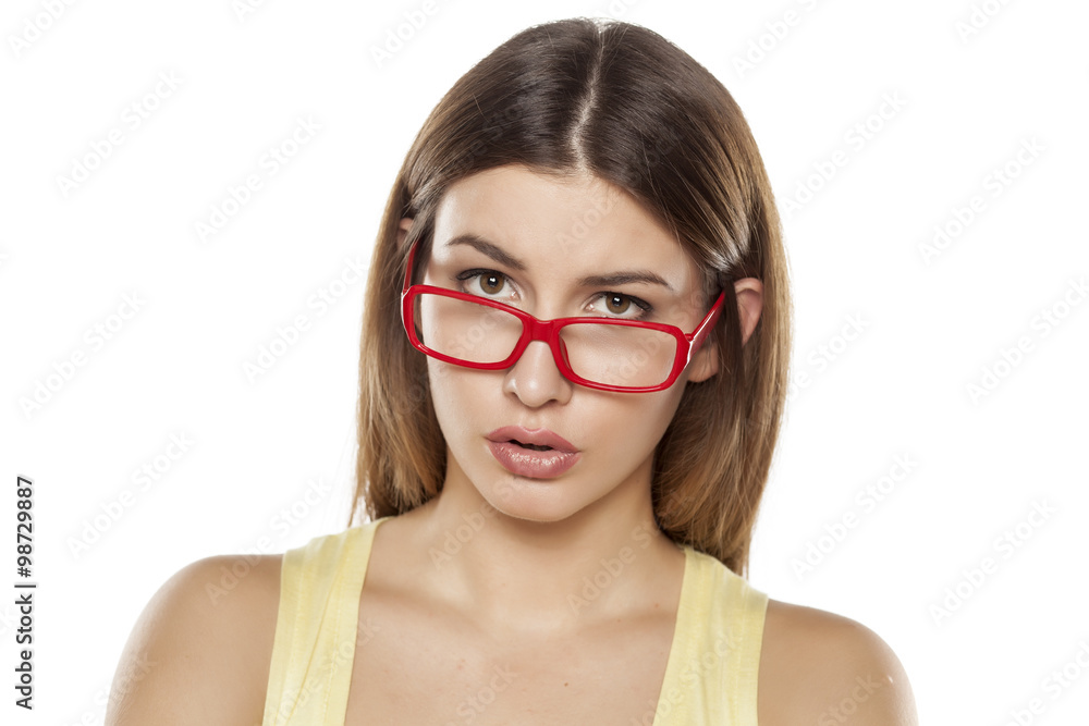 young beautiful woman with red glasses on a white background young beautiful woman with red glasses on a white background