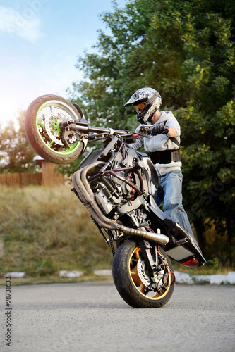 Feel the adrenaline rush. Extreme biking stunt performer practicing tricks on the road soft smudged focus
