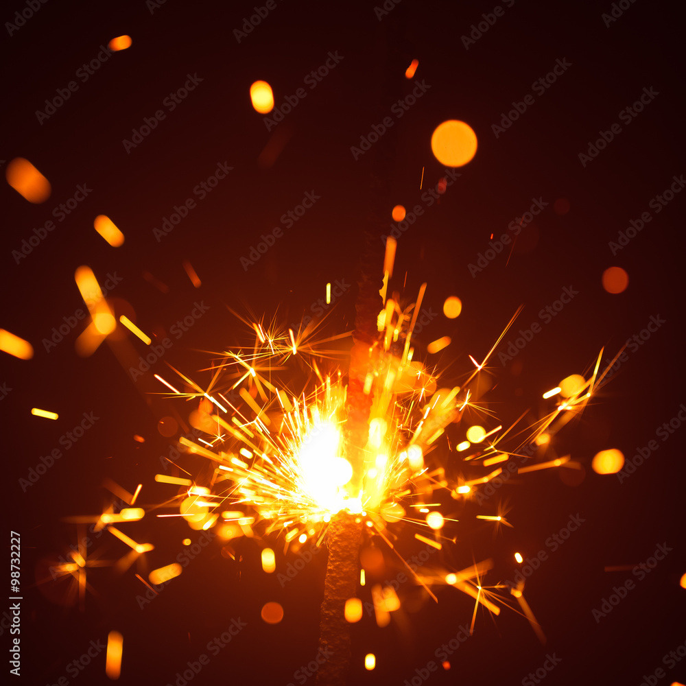 Obraz premium Christmas sparkler in haze with red light