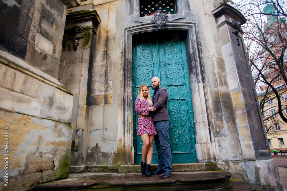 beautiful young couple in love standing near historic building.