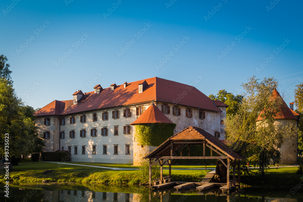 Otocec, Slovenia - September 12, 2015. Grad Otocec, castle in the middle of the river Krka with its dock for boats.