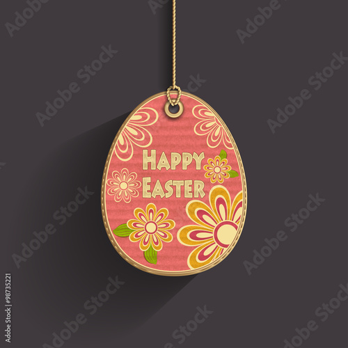 Egg on cord with  corrugated cardboard texture and flowers on dark