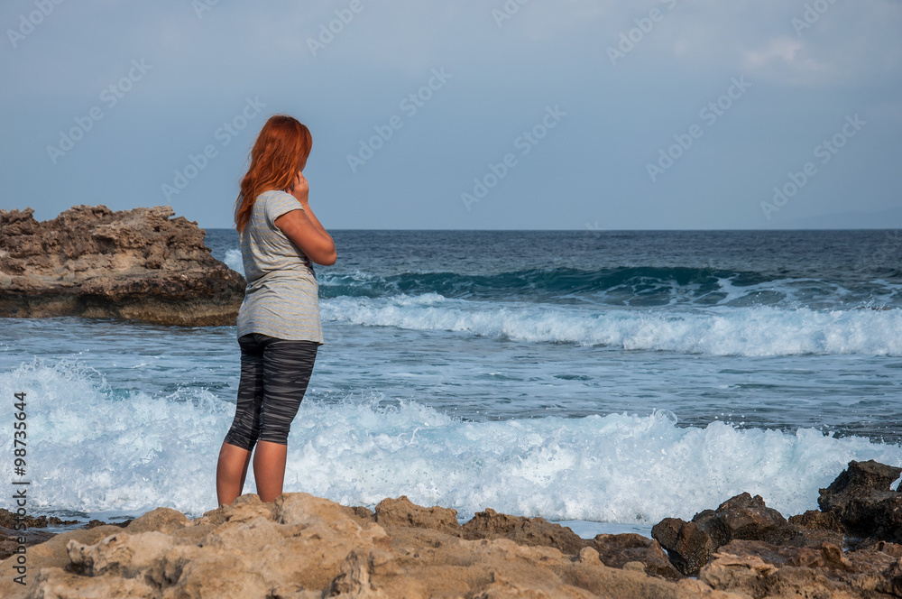young woman looking at sea
