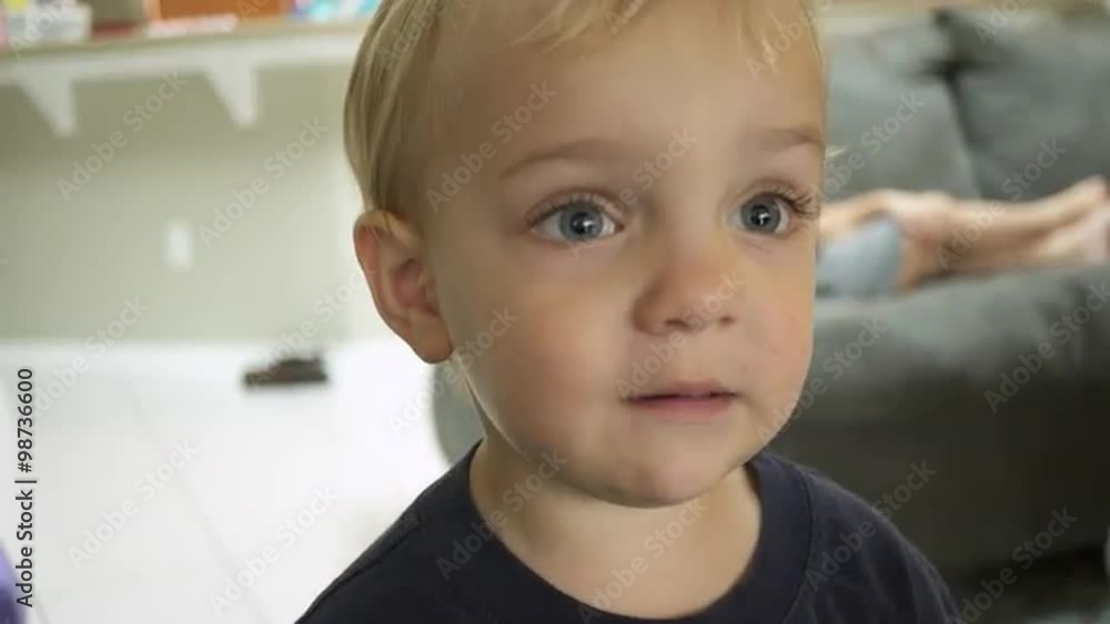 Close up view of a little boy dressed in a blue shirt Close up view of a little boy dressed in a blue shirt