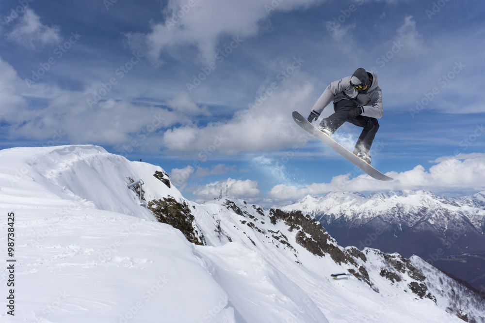 Flying snowboarder on mountains. Extreme sport. Flying snowboarder on mountains. Extreme sport.