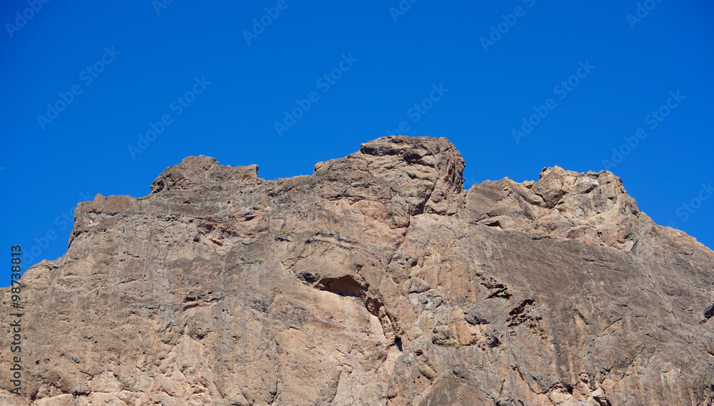 top of a mountain under blue sky