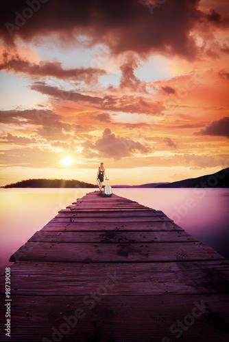 Young woman walking on wooden pier.