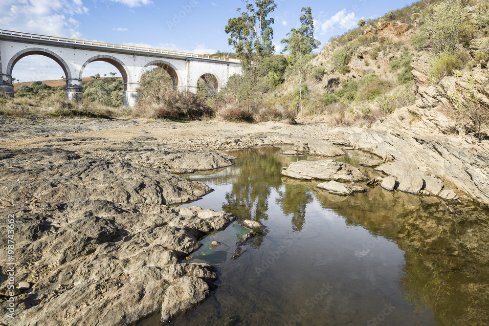 bridge over Terges e Cobres brook with stones, Mértola, Portugal