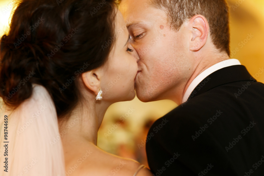 Handsome tender groom kissing emotional brunette bride closeup Handsome tender groom kissing emotional brunette bride closeup