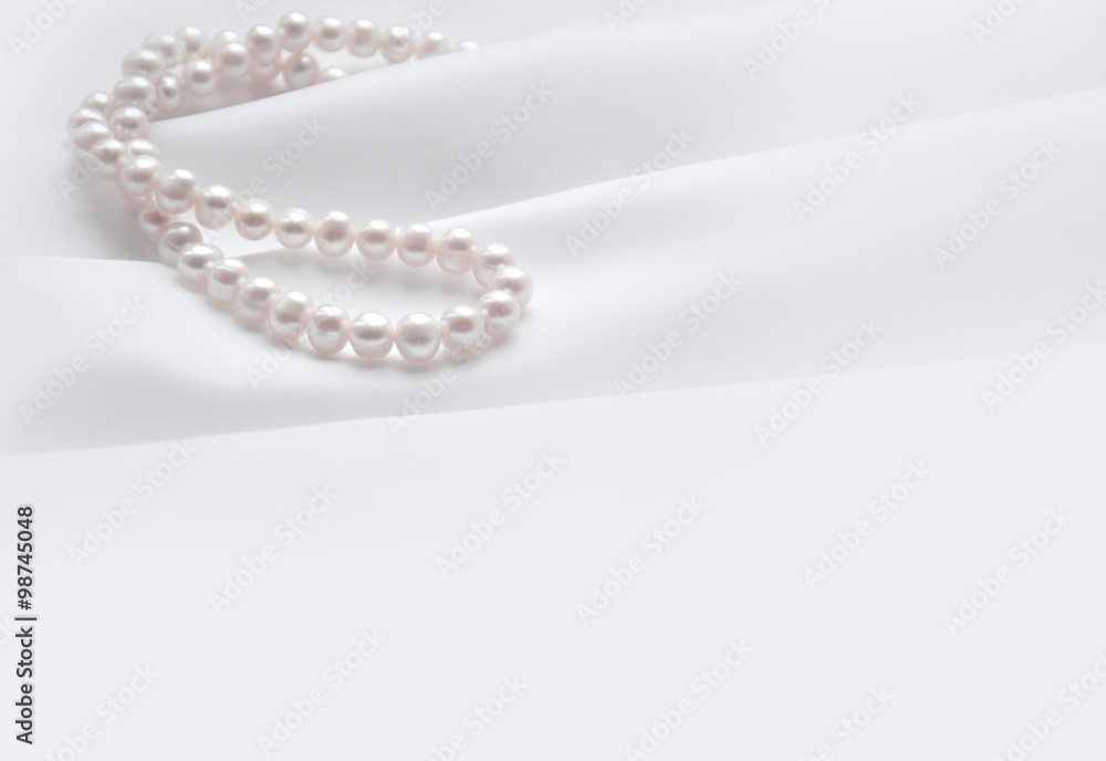 Elegant white background with silk and pearl Elegant white background with silk and pearl