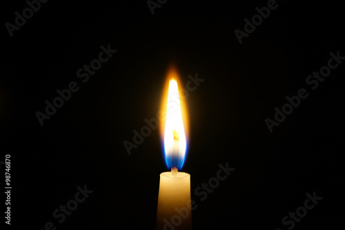 burning candle isolated on black