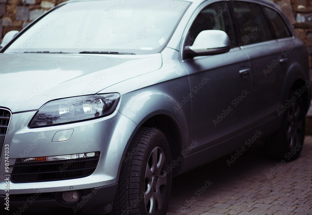 big silver car over a brick wall big silver car over a brick wall