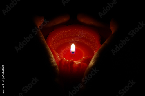 burning candle in the hands 