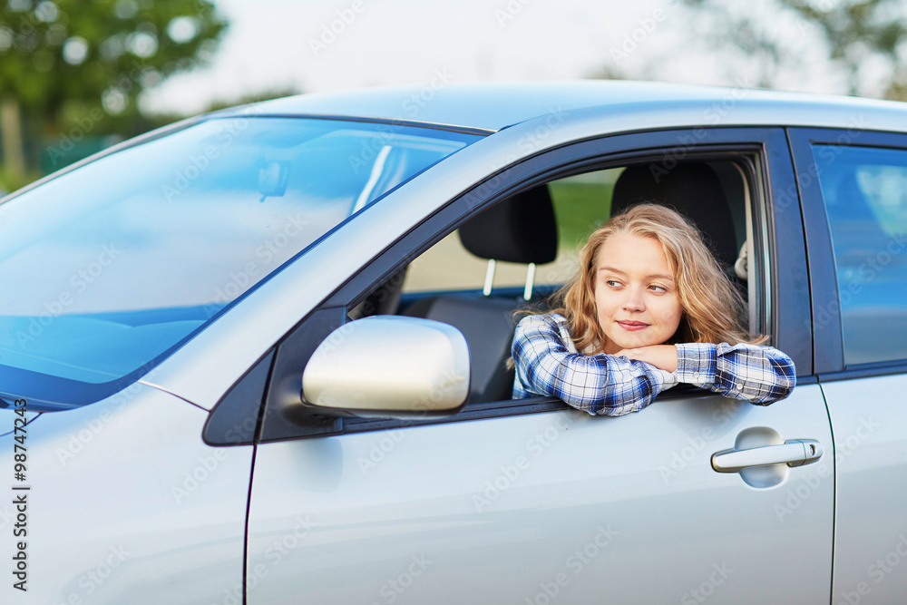 Young confident woman driving a car Young confident woman driving a car