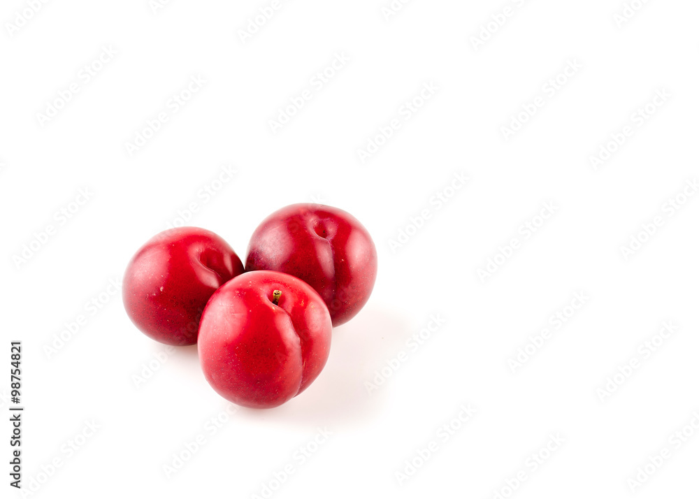Decorative little myrobalan plums on white with copyspace Decorative little myrobalan plums on white with copyspace