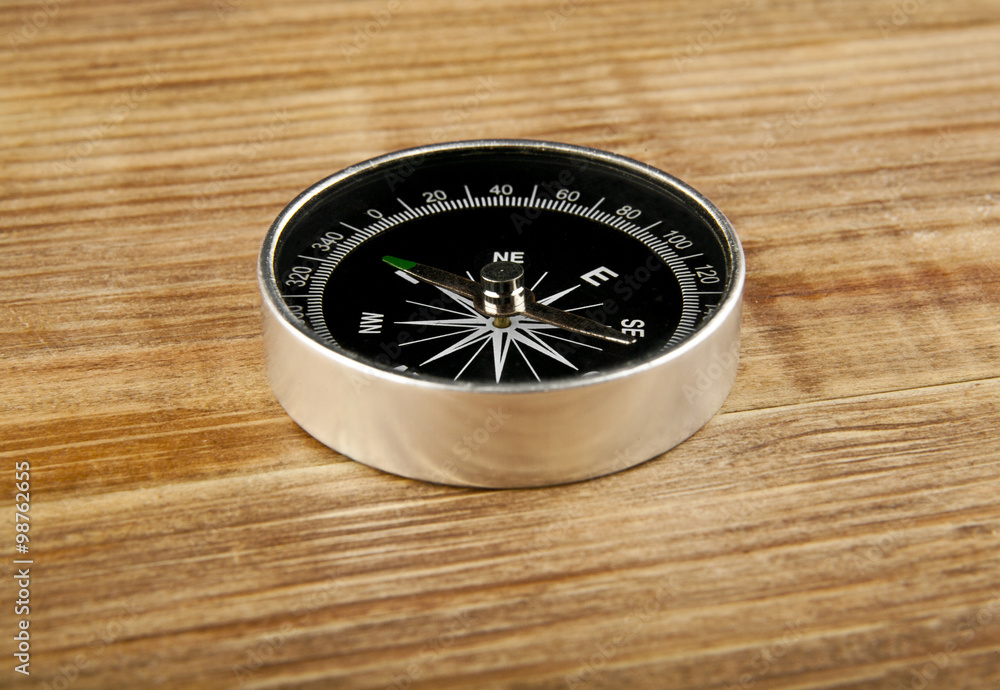 compass on wooden background with space for text compass on wooden background with space for text