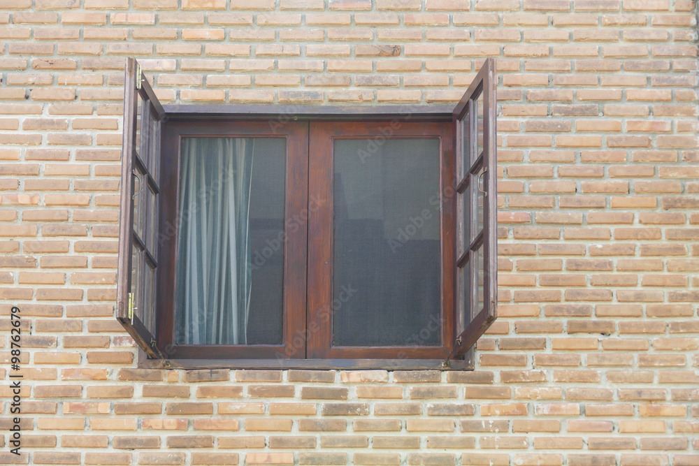 old wooden window on brick wall