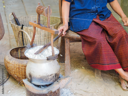 Boiling cocoon silkworm in a pot to prepare silk thread