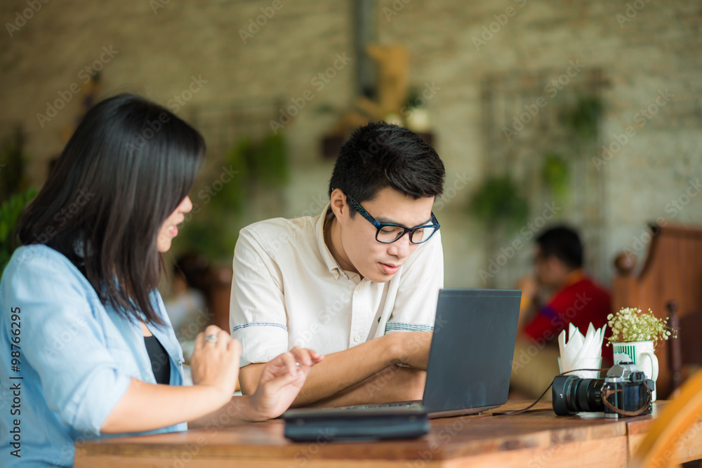 Young businessman and businesswoman using laptop Young businessman and businesswoman using laptop
