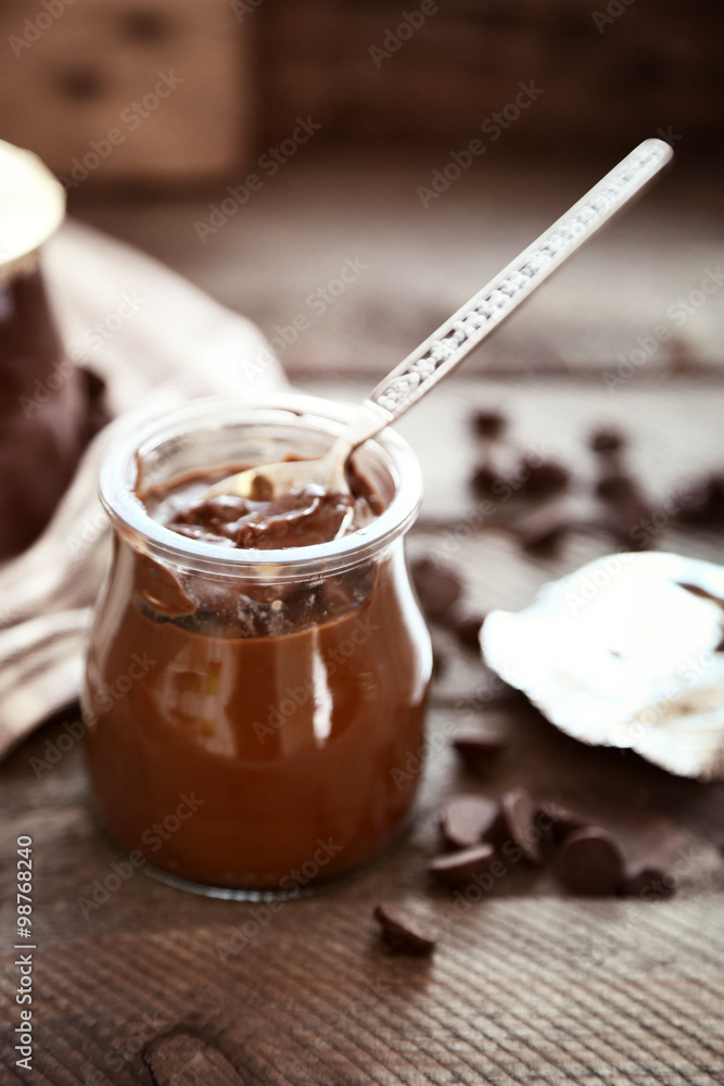 Chocolate dessert in a small glass jars on wooden background Chocolate dessert in a small glass jars on wooden background