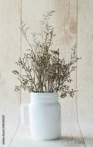 dried flower in white vase