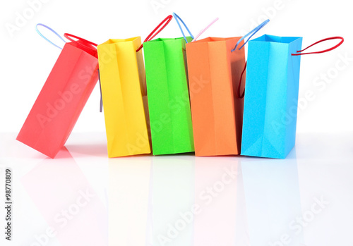 Shopping colorful sale paper bags close-up on a white