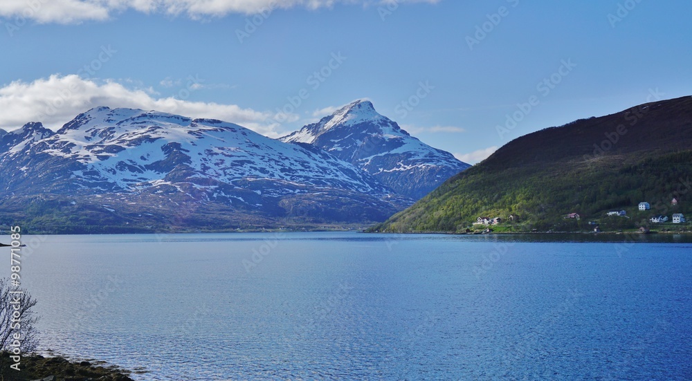 Norwegian landscape around Tromso with mountains and lakes under the midnight sun